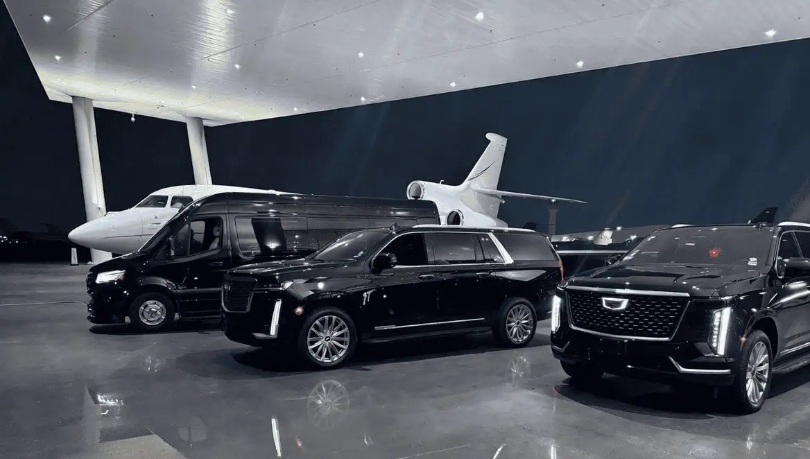 Professional Metheora Limo chauffeur in dark suit opening the rear door of a black Cadillac Escalade ESV at the VIP arrival lane outside Hard Rock Stadium Miami Gardens, elegantly dressed couple stepping out, Brazil and Portugal soccer fans with scarves visible in background, FIFA World Cup 2026 Miami limo service